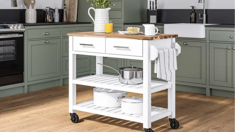 kitchen cart set up for use as an island in a modern green kitchen