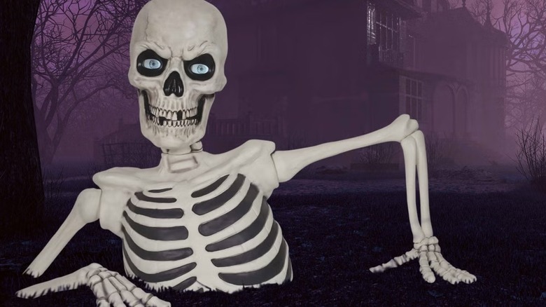 A giant skeleton breaking out of the ground with a house in the back