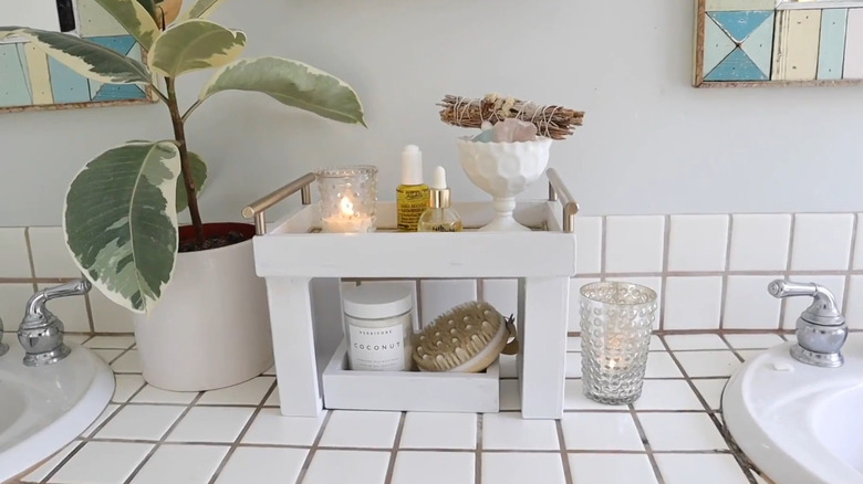 Countertop stand made from old canvases with bathroom items on them