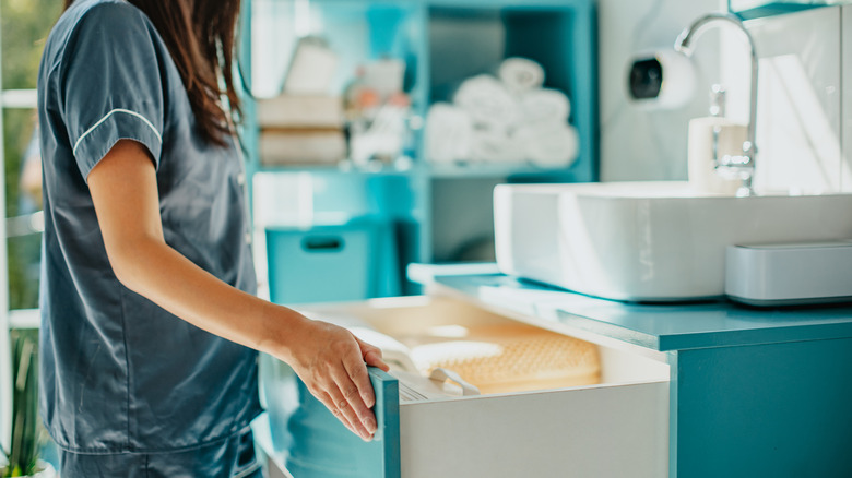 Woman organizing a bathroom