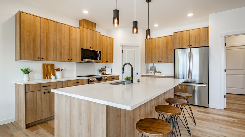 A modern wooden kitchen with sharp countertop edges