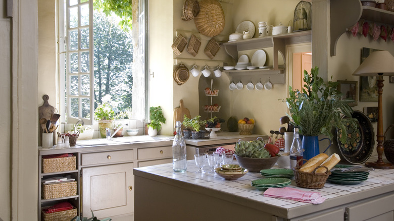 A rustic kitchen with an island with a tile surface