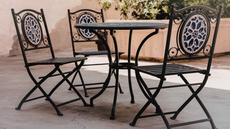 Metal table and chairs on cracked concrete patio