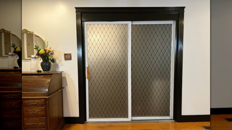 Frosted black lattice window film installed on sliding glass doors in a living room