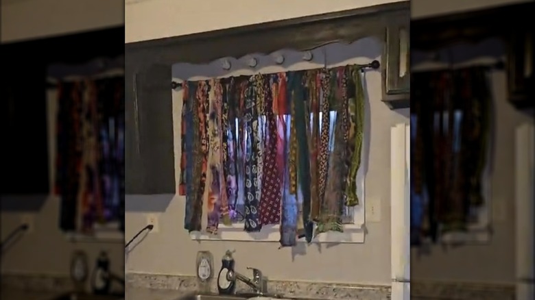 Fabric strands from chindi rug turned into DIY kitchen curtain