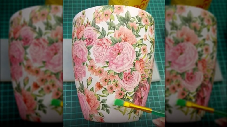 Person decoupaging a planter