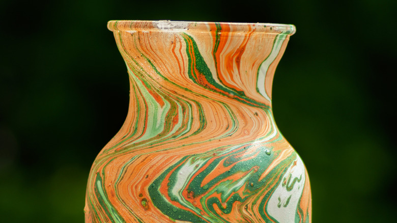 A red, green, orange, and gold hydro dipped vase.