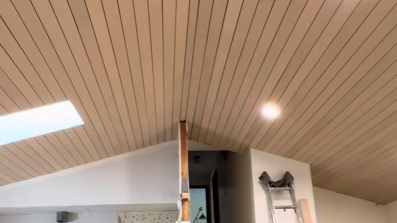 Slat ceiling with ladder leaning on wall