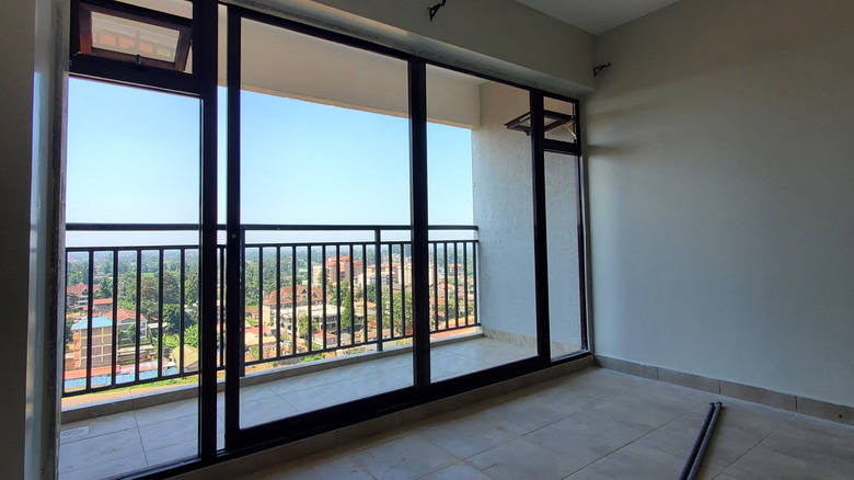 sliding glass doors with no covering looking out on a balcony