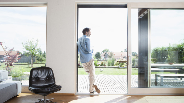Sliding glass doors open with house beyond