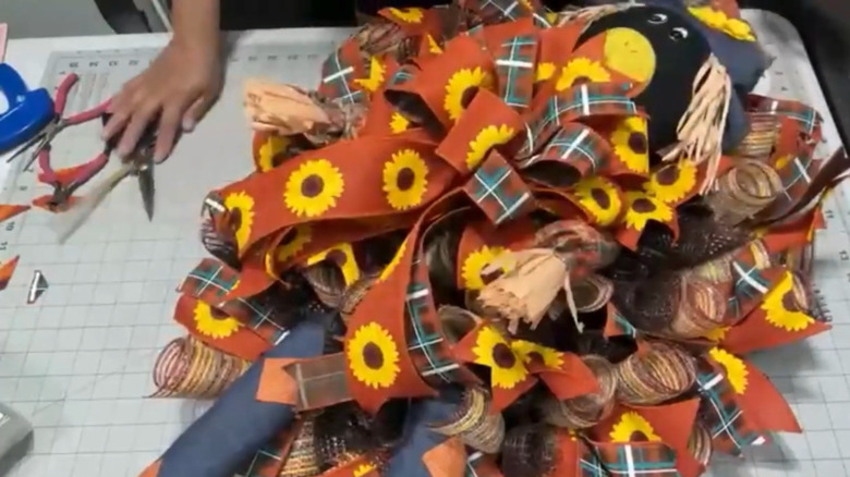 Wreath with a stuffed scarecrow in the center