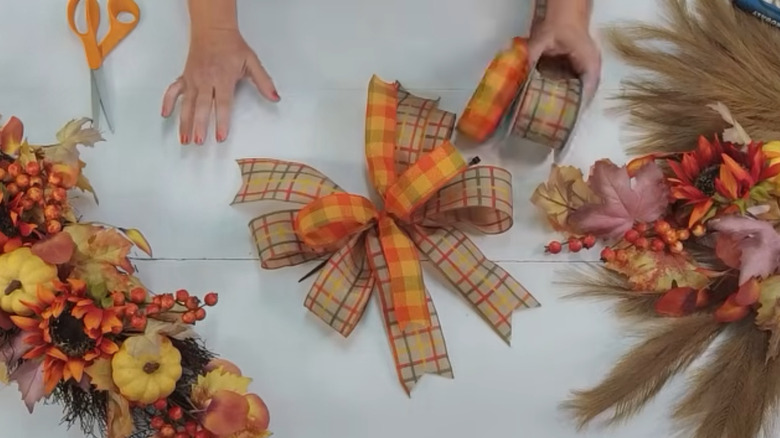 A large bow made from orange ribbons