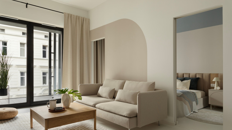 a living room with curtains halfway between ceiling and window top