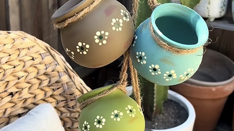 Painted terracotta pots with floral designs as a windchime