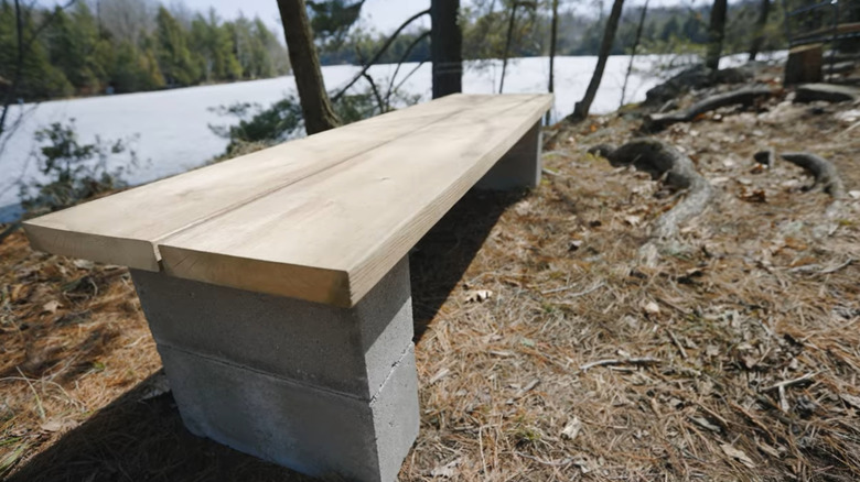 A bench with concrete block legs and a wooden top
