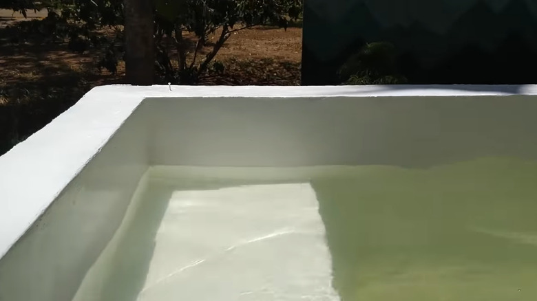 A concrete block pool full of water