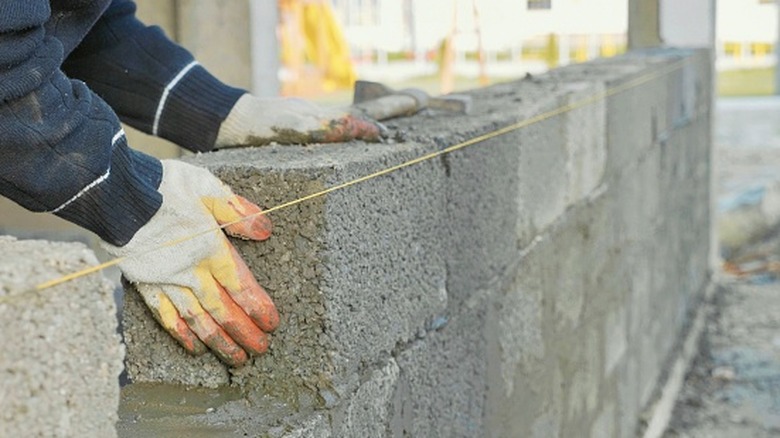 Person arranging concrete blocks