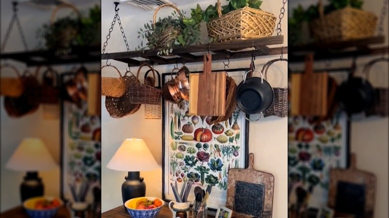 Old wooden ladder hanging horizontally with pots and pans hanging off of it