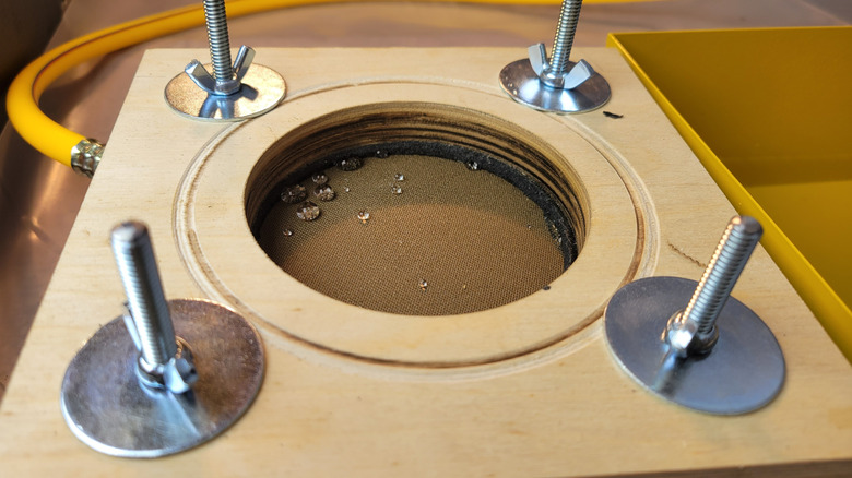 Drops visible on treated fabric after a small amount of pressure was applied