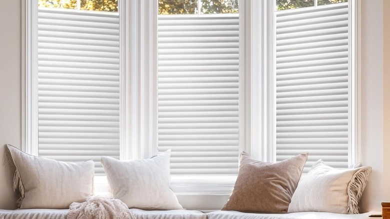 Cling film mimicking window blinds with realistic shading on a bay window