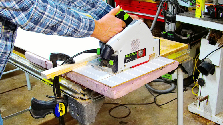 Cutting sheet stock with circular saw using a straightedge and foam backer.