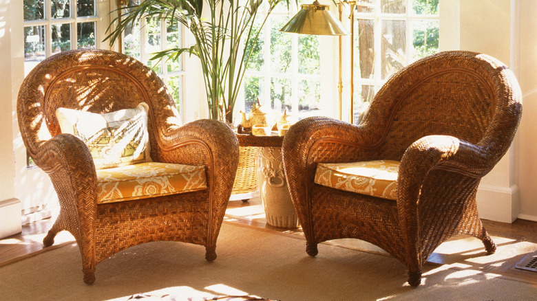 Two rattan chairs in a sunny corner of a home