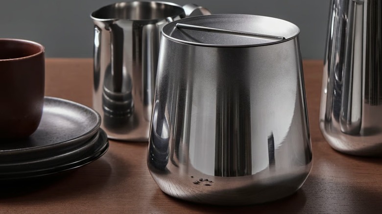 IKEA AFTONHAJ Jar with lid on table next to other silver kitchen carafe and jar