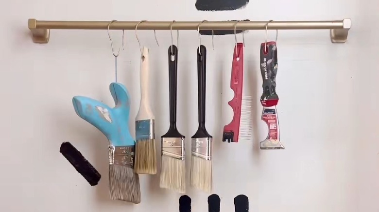 A towel bar turned into an organizer for paint supplies