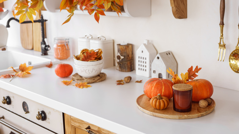countertop decorated for fall with autumn leaves