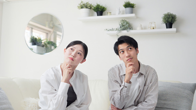 Couple contemplates how to decorate their living room