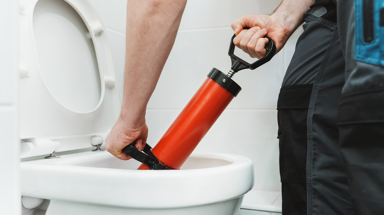 Fixing a clogged toilet with a taze-style plunger