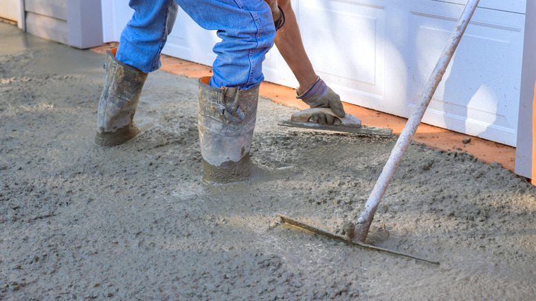 Contractor pouring concrete driveway