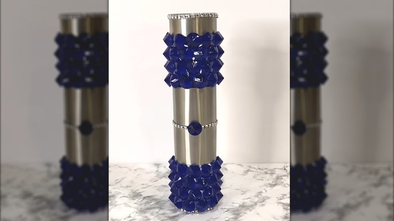 Glam solar light with blue diamond-shaped gemstones glued on the clear portions