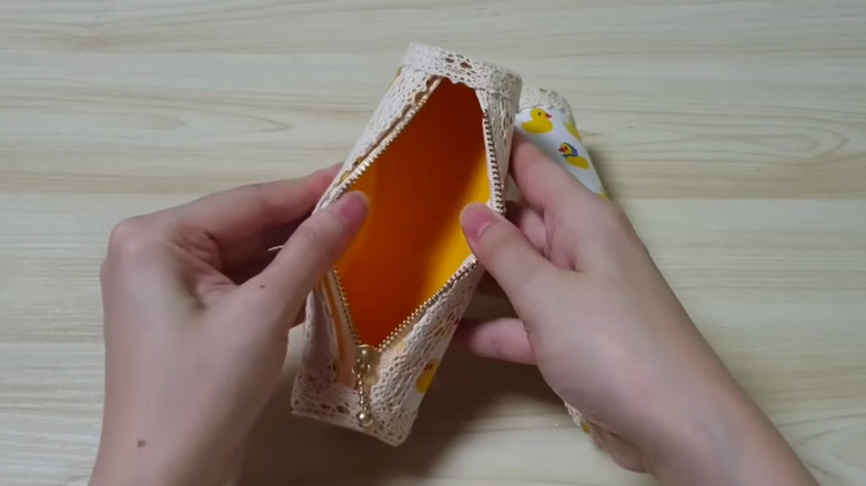 YouTuber Merry Craft demonstrates how she creates her own storage roll.