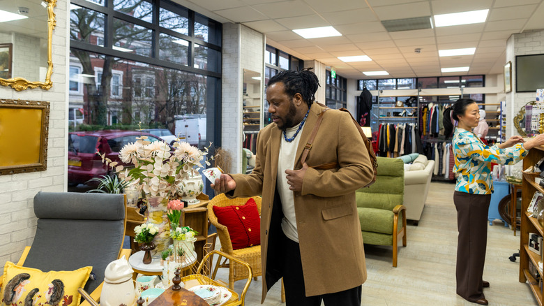 People shopping in the furniture section of a thrift store