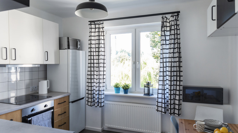 White and black curtains in plain kitchen