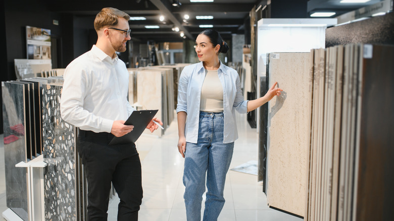 Woman talking with a salesperson in a kitchen showroom