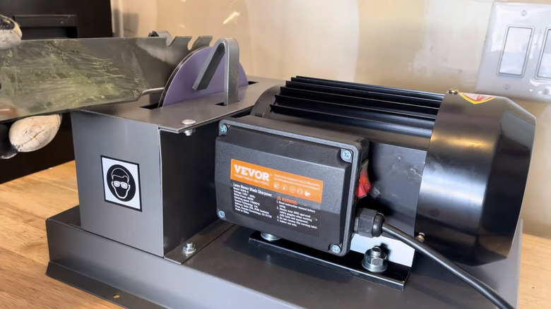 Homeowner using VEVOR lawnmower blade sharpener