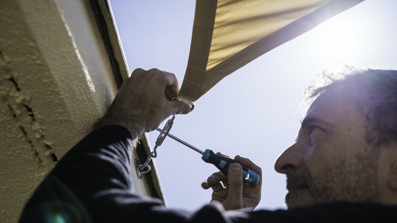 Man installing a shade sail