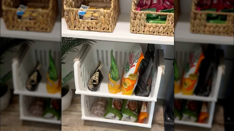 Dollar Tree stackable bins filled with food items on closet floor