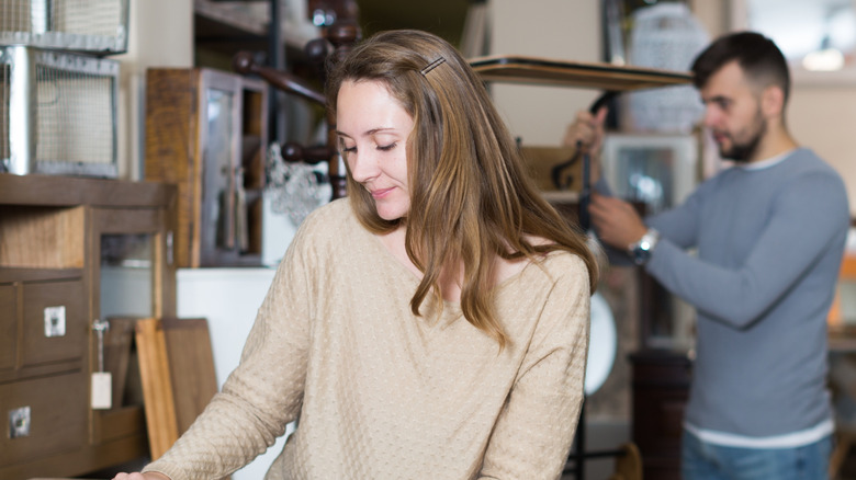 A man and a woman shop for vintage finds in a thrift store
