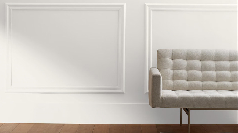 Alabaster wall with white couch in foreground