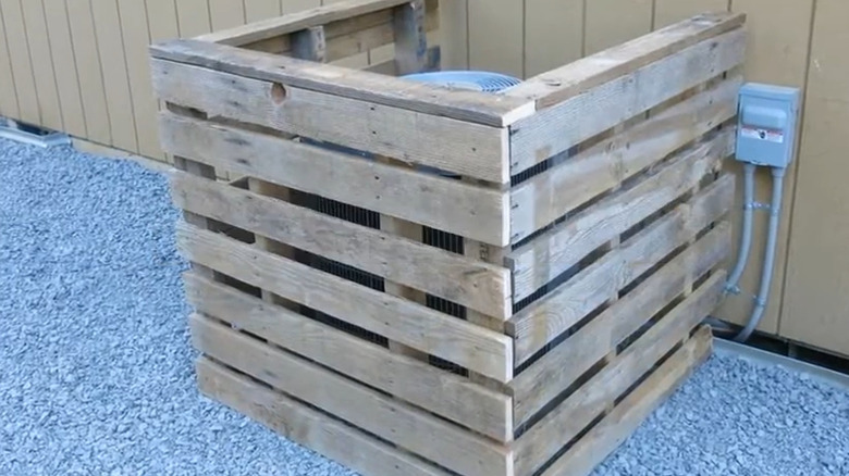 DIY pallet AC cover surrounding an outdoor AC unit