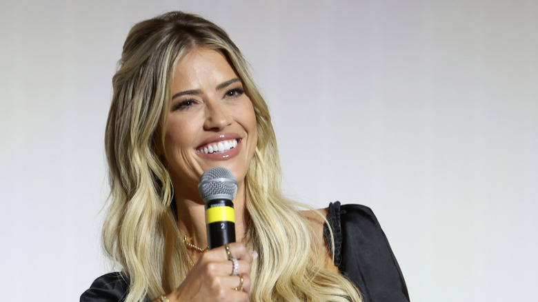 Close up of Christina Haack with a microphone in hand.