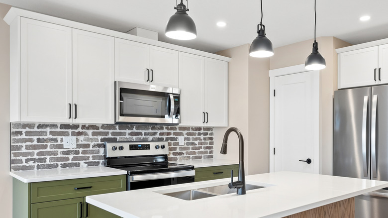 Kitchen with a rustic brick backsplash