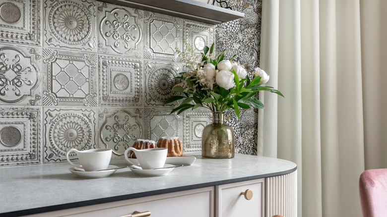 A kitchen with a metal tile backsplash