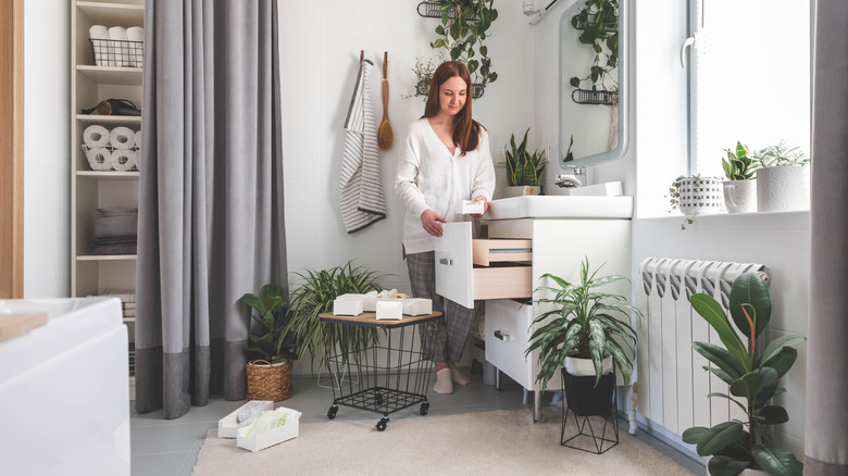 Woman organizing items in the bathroom