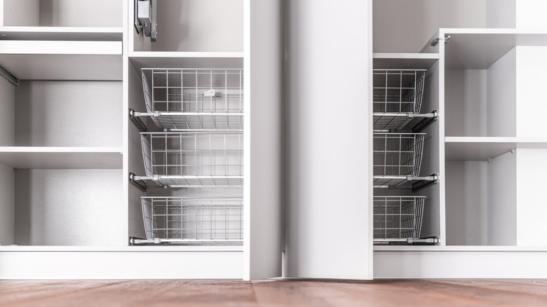 close up of a white wardrobe build with drawers, baskets and doors from ground up