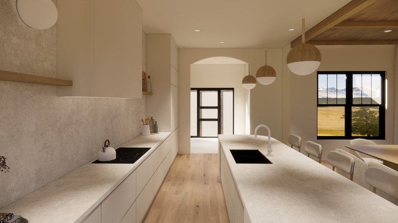 A modern kitchen with cream cabinets and backsplash and walnut accents