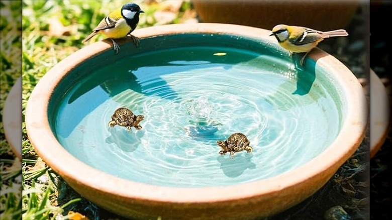 Small copper turtle purifying disks in a birdbath with two birds on the edges